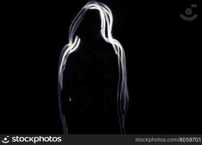 A silhouette of a girl on a black background. Glow white-purple line is around her.
