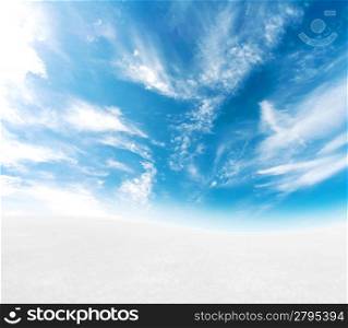 A simple tranquil beautiful S-curved horizon with blue sky and snowy hills.