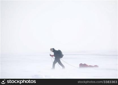 A single person on a winter expedition in a snow storm
