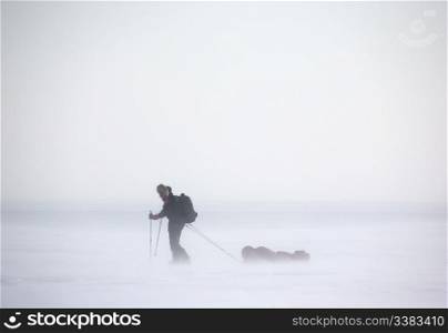 A single person on a winter expedition in a snow storm