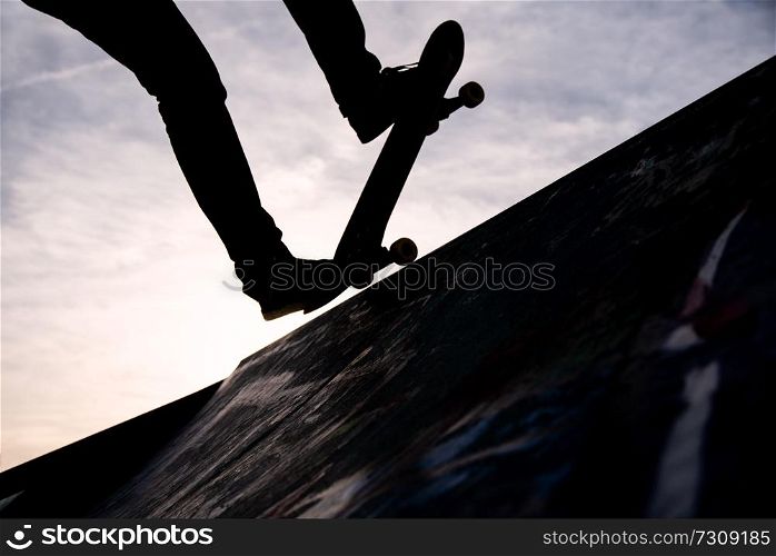 a Skater riding the skate in a skate park only from the knee down