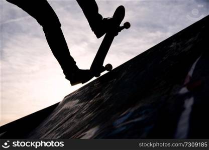a Skater riding the skate in a skate park only from the knee down