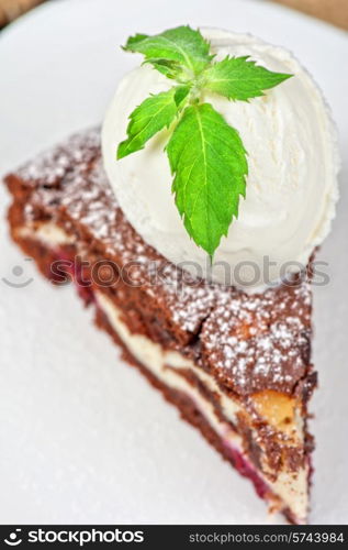 A slice of chocolate cake with ice cream