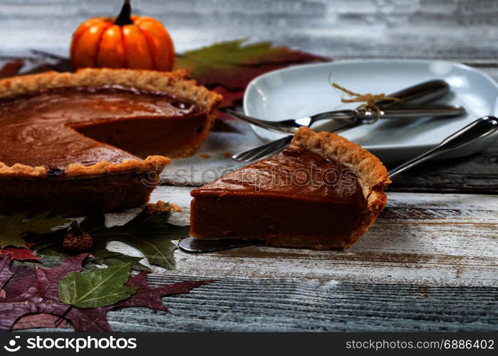 A slice of fresh homemade pumpkin pie for Thanksgiving ready to eat