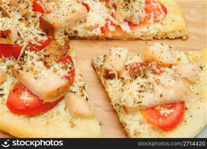 A slice of grilled chicken, fresh tomatoes, garlic and grated Asiago cheese top this gournet pizza for one topped off with dried herbs and spices.. Chicken Pizza For One