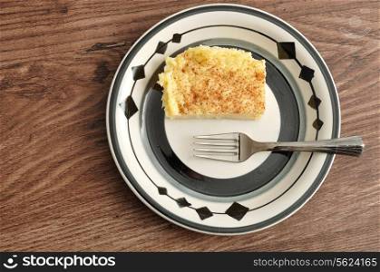A slice of milk tart with a cake fork