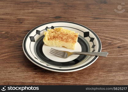 A slice of milk tart with a cake fork