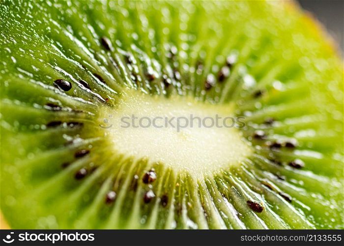 A slice of ripe kiwi. Macro background. Kiwi texture. High quality photo. A slice of ripe kiwi. Macro background.