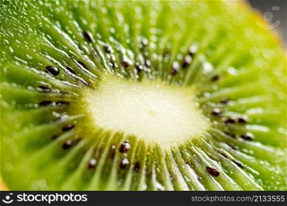A slice of ripe kiwi. Macro background. Kiwi texture. High quality photo. A slice of ripe kiwi. Macro background.