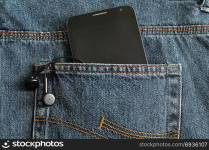 A slim phone and earphones in a back pocket of a jean