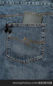 A slim phone and earphones in a back pocket of a jean