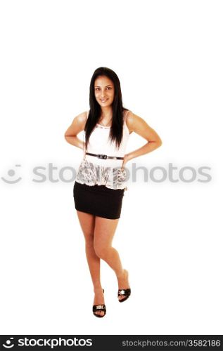 A slim teenager girl standing for white background,wearing a short black skirt and white blouse and high heels.