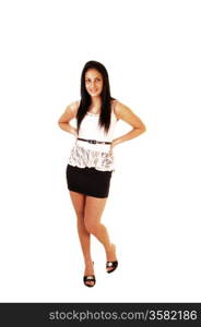 A slim teenager girl standing for white background,wearing a short black skirt and white blouse and high heels.