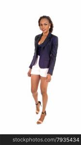 A slim young African American woman in white shorts and a grey jacketand high heels, standing isolated for white background.