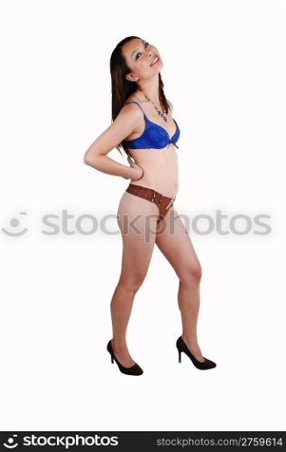A slim young Chinese woman in blue and brown underwear standing in the studio on high heels and having fun, on white background.