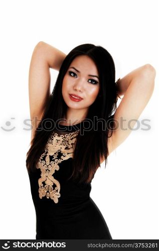 A slim young Chinese woman standing in a black dress and longblack hair for white background.