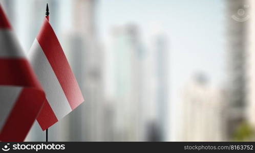 A small Austria flag on an abstract blurry background.. A small Austria flag on an abstract blurry background