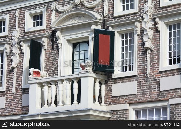 A small balcony on a historic dutch facade