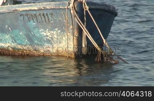 A small boat is fixed on a morring.