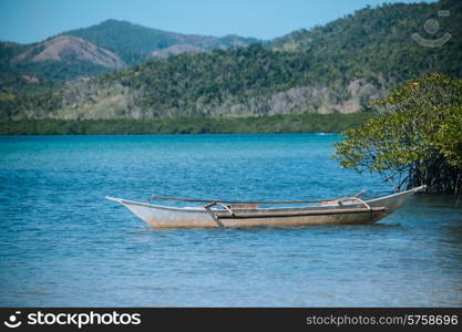 A small boat on a tropical beach