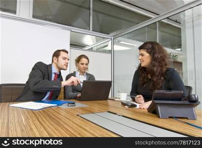 A small business team in a cubicle conference room during a meeting