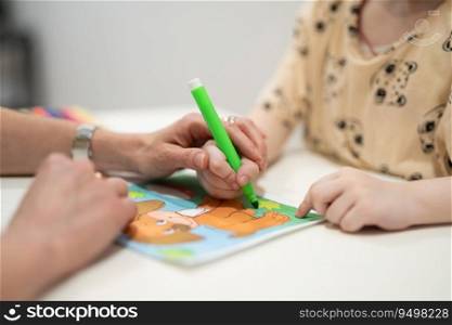 a small child is learning to draw a picture