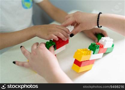 a small child plays with a constructor while building