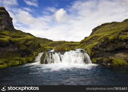 A small, hidden and obscured waterfall in the Icelandic National Park Landmannalaugar
