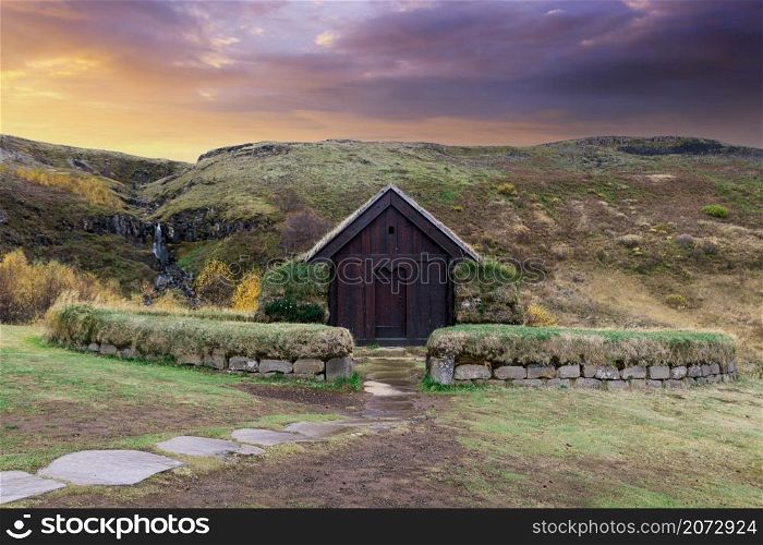 a small hut in south Iceland with a colorful sunset