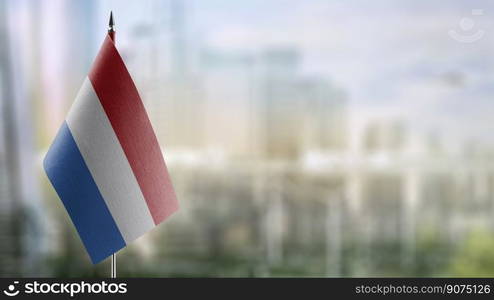 A small Netherlands flag on an abstract blurry background.. A small Netherlands flag on an abstract blurry background