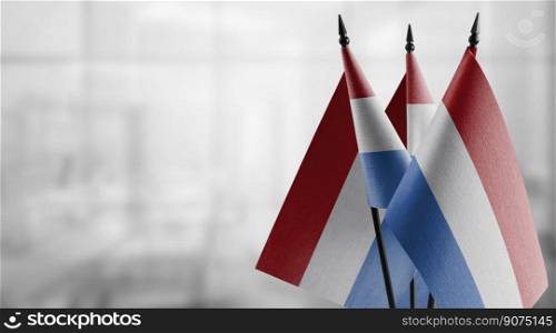 A small Netherlands flag on an abstract blurry background.. A small Netherlands flag on an abstract blurry background