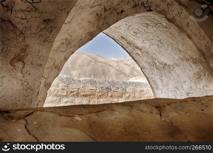 A small portion of the Negev Desert is viaible through an arch in an un-named