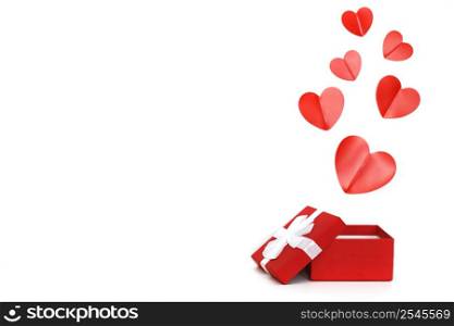 a small red present box with red hearts on a white background. red present box with red hearts on a white background