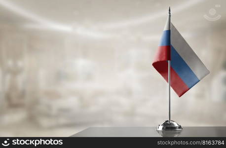 A small Russia flag on an abstract blurry background.. A small Russia flag on an abstract blurry background