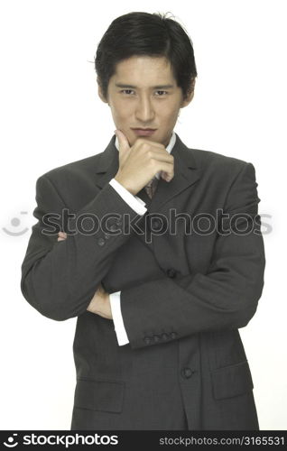 A smart and smooth asian businessman in a grey suit with white shirt and pink tie