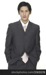A smart asian businessman in grey suit with white shirt and pink tie