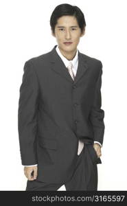 A smart asian businessman in grey suit with white shirt and pink tie