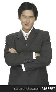 A smart asian businessman with folded arms give a slight smile