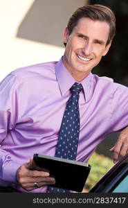A smart man successful businessman outside with a tablet computer