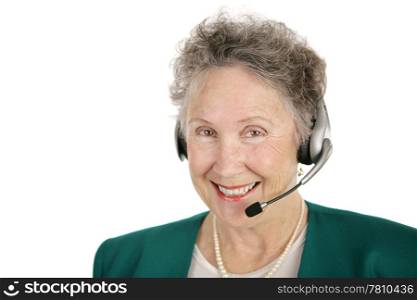 A smiling, cheerful senior lady with a telephone headset. Isolated on white.