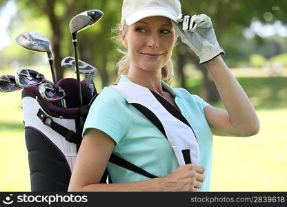 A smiling female golfer.