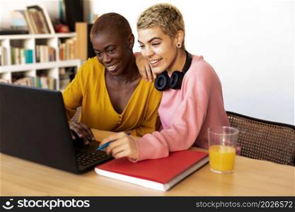 A Smiling females using laptop at office. A Smiling women using laptop at office