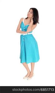 A smiling gorgeous young woman standing in full length in a blue dress,isolated for white background.