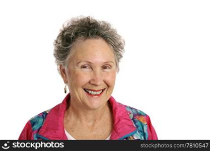A smiling, happy retired woman wearing a pink jogging suit. Isolated on white.
