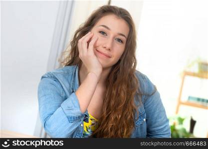 a smiling pretty young woman with blue jeans jacket