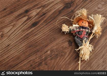 A smiling scarecrow isolated against a wooden background