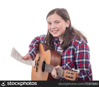 a smiling teenager girl playing an acoustic guitar on white