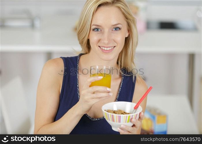 a smiling woman eating breakfast