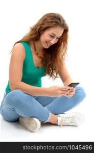 a smiling woman in green casual smart clothing, sitting crossed legs, holding smartphone