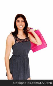 A smiling young brunette woman holding some shopping bag&rsquo;s over hershoulder, isolated over white background.